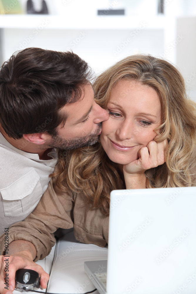 Husband kisses wife on the cheek. Husband kisses wife on the cheek.