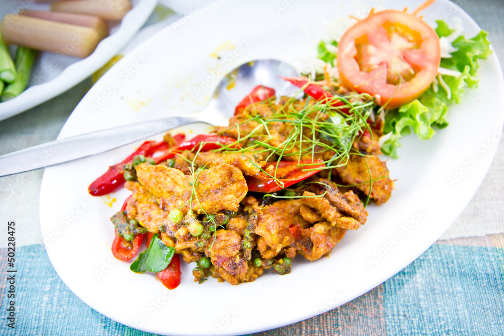 Dried pork with spicy curry on white plate in restaurant Dried pork with spicy curry on white plate in restaurant