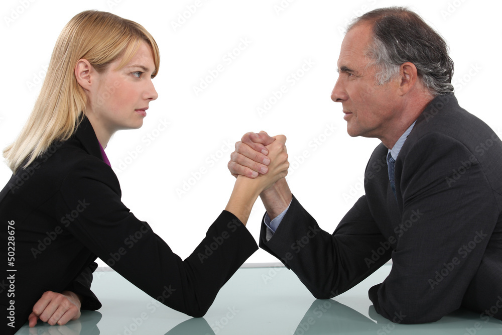 Businessman and woman arm wrestling Businessman and woman arm wrestling