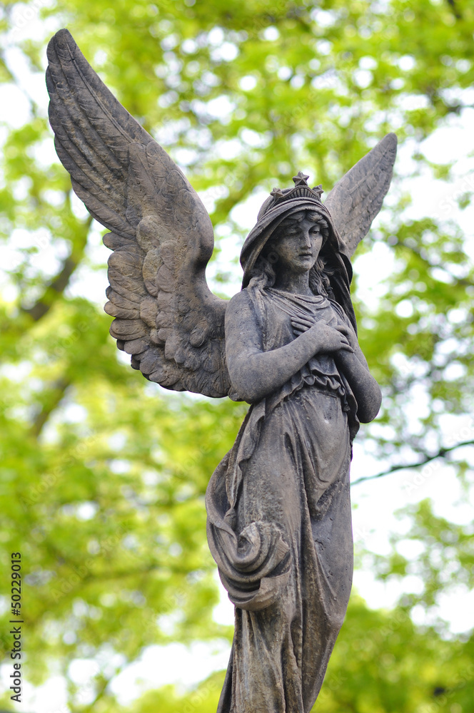 Fototapeta premium Sculpture of Angel at a old Prague cemetery Vysehrad