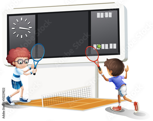 Two boys playing tennis with a big scoreboard