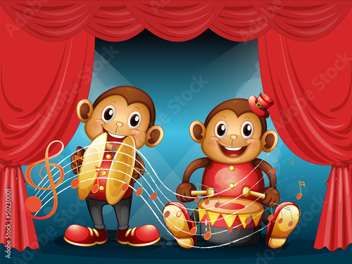 Two monkeys performing at the stage