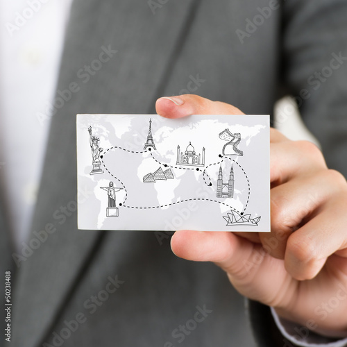 Businesswoman holding business card with world map and famous to