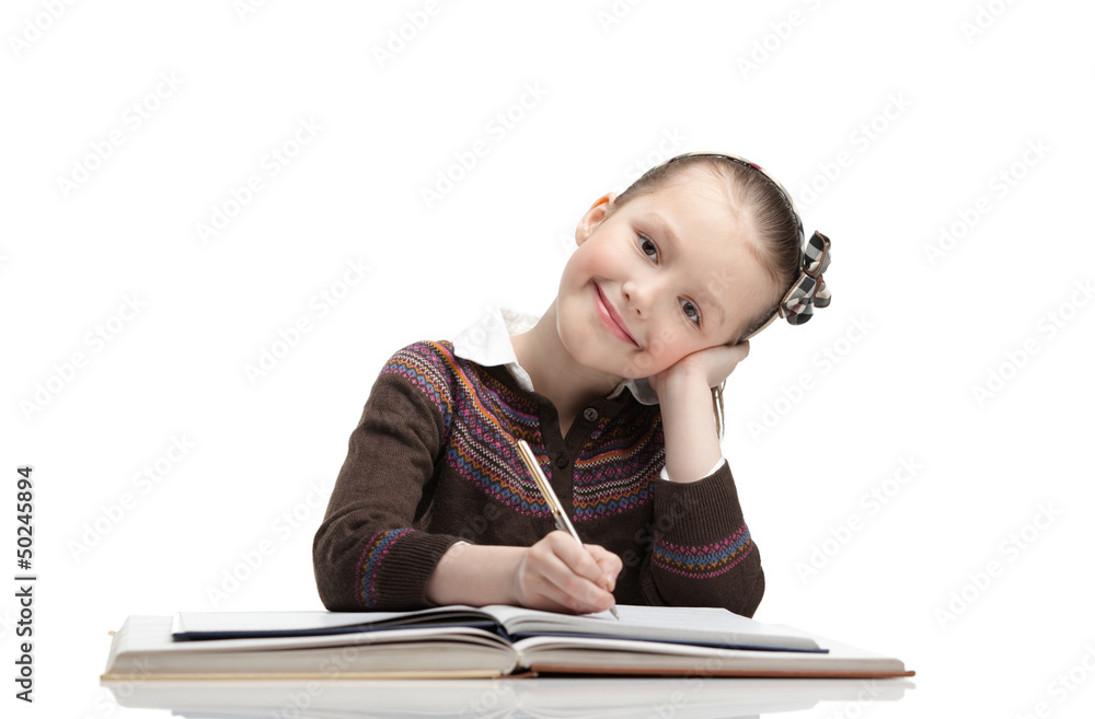 Pupil writes something at the paper, isolated, white background Pupil writes something at the paper, isolated, white background