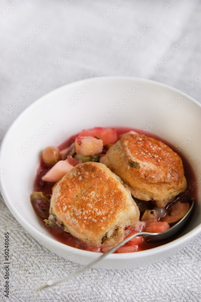 Spicy fruit cobbler in a white bowl