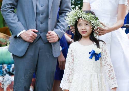 Cute little flower girl in the wedding ceremony