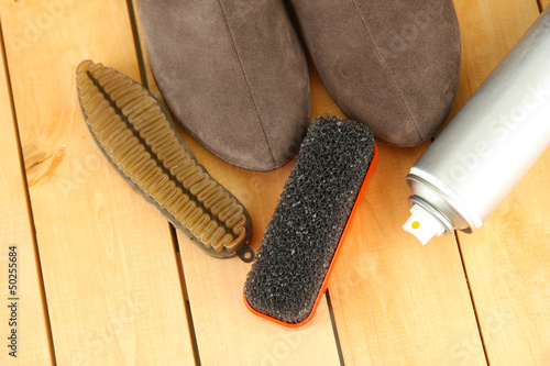 Set of stuff for cleaning and polish shoes, on wooden