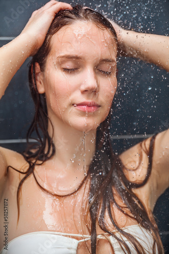 Young beauty under shower
