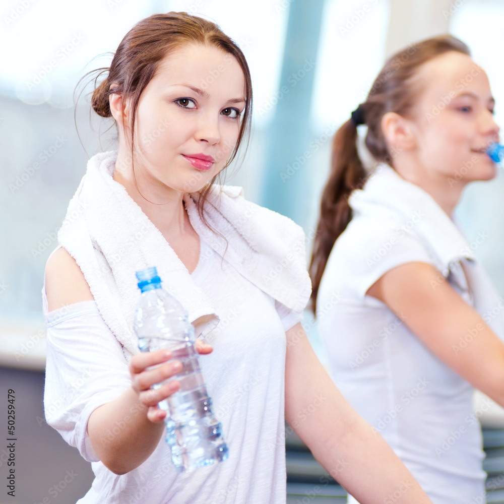 Women drinking water after sports