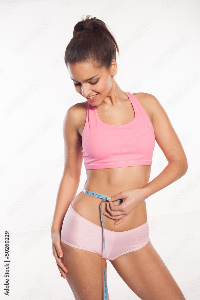 Obraz premium Slim woman measuring her waist