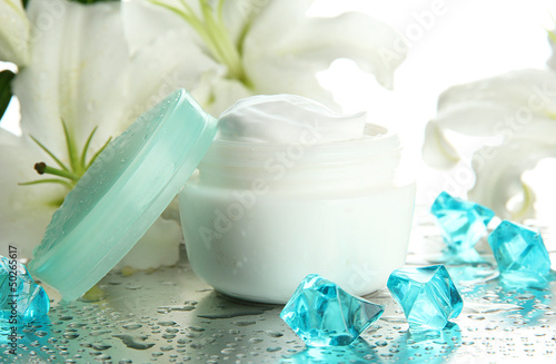 Fototapeta Naklejka Na Ścianę i Meble -  Cosmetic cream and beautiful lily, close up