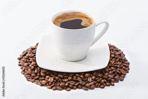 Coffee cup on coffee beans