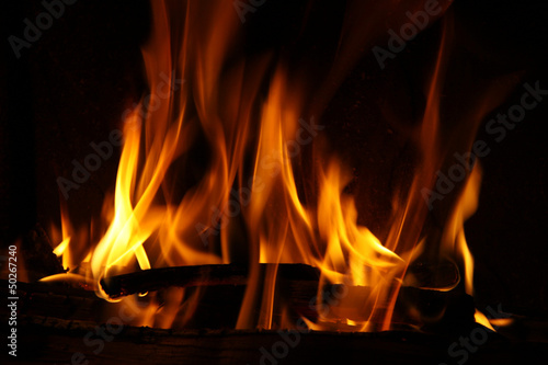 Fire in a fireplace, fire flames on a black background #50267240
