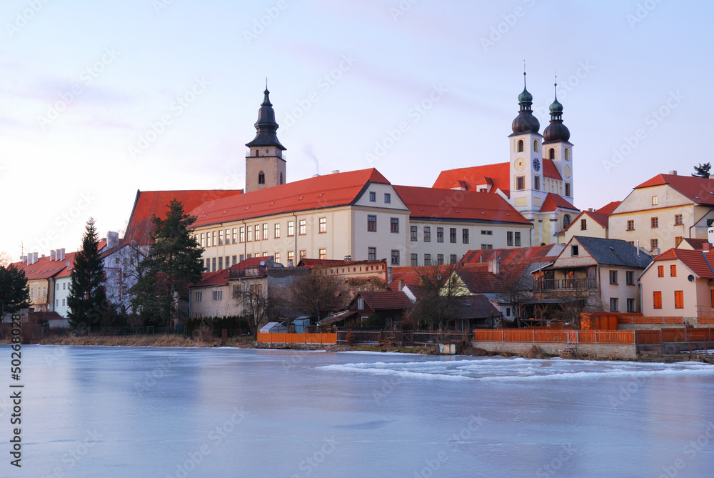 Telc historic chateau and church towers in sunset light