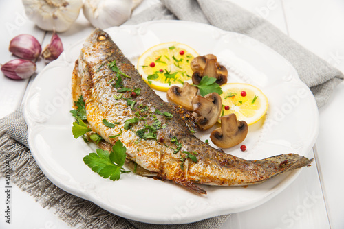 Roasted fish with lemon, mushrooms and herbs