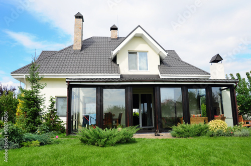 A new house with a garden in a rural area under beautiful sky photo