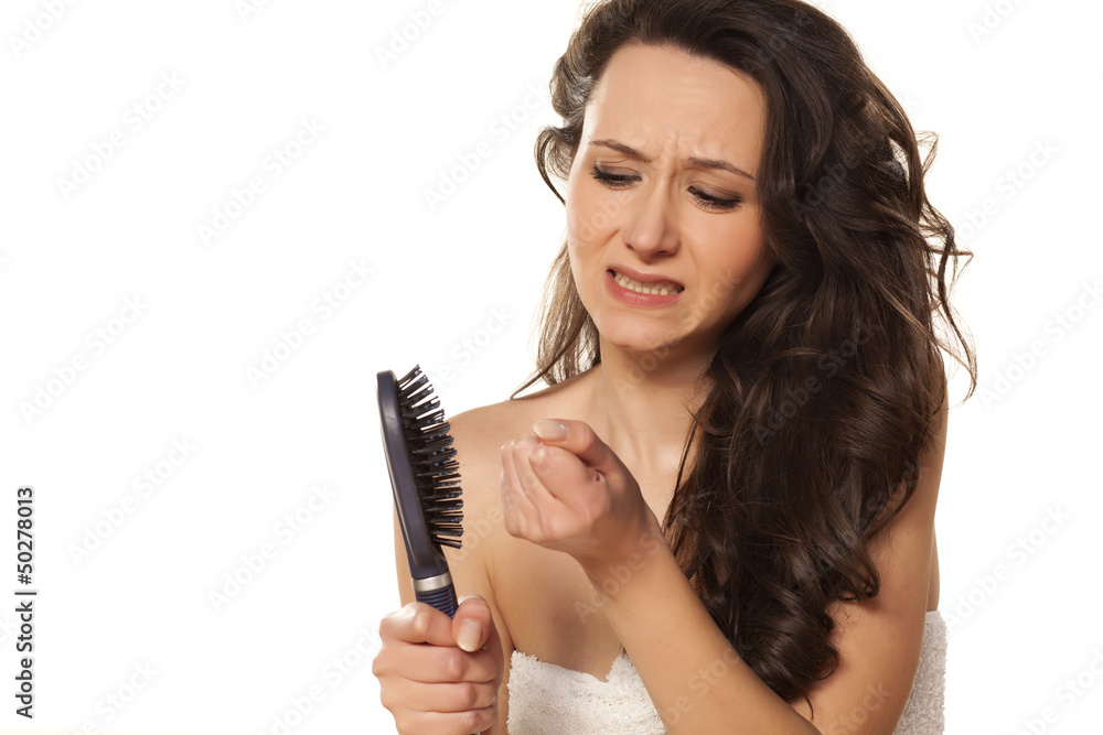 girl is very nervous about the loss of hair on white background girl is very nervous about the loss of hair on white background