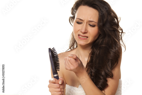 girl is very nervous about the loss of hair on white background