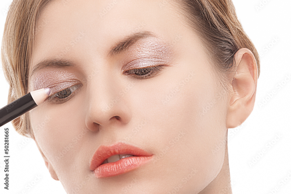 closeup of young blond caucasian woman applying makeup closeup of young blond caucasian woman applying makeup