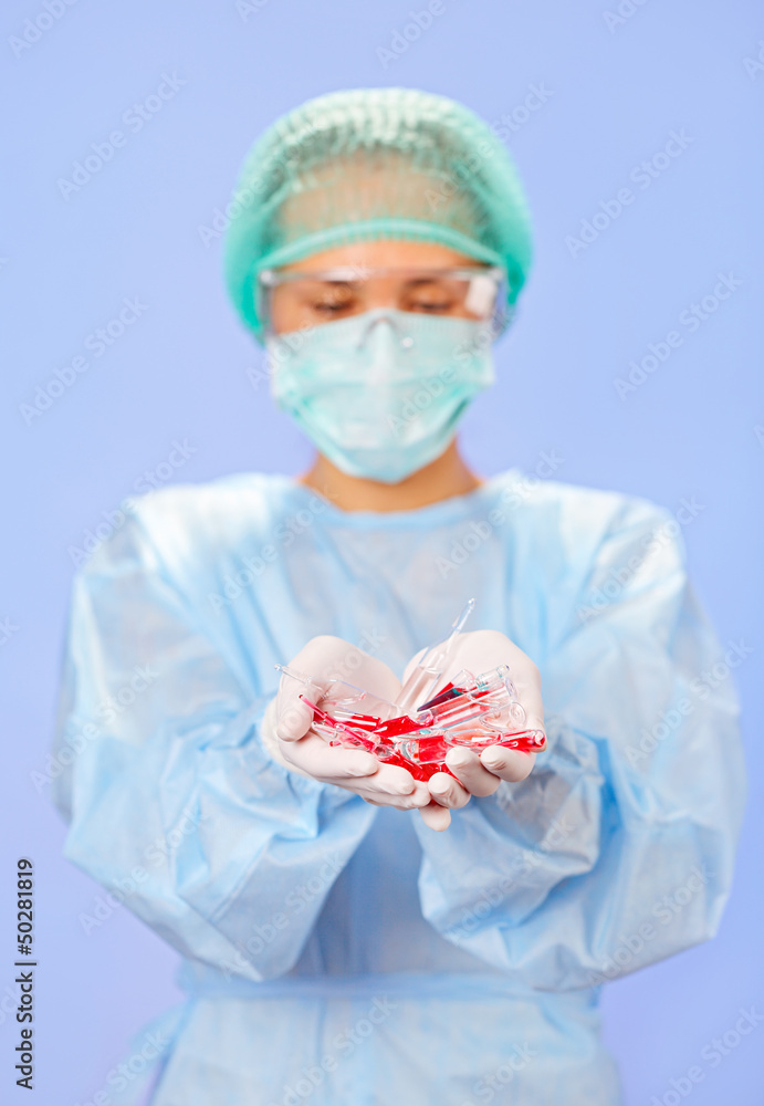 Doctor (woman) holding many medical ampoules in her hands Doctor (woman) holding many medical ampoules in her hands