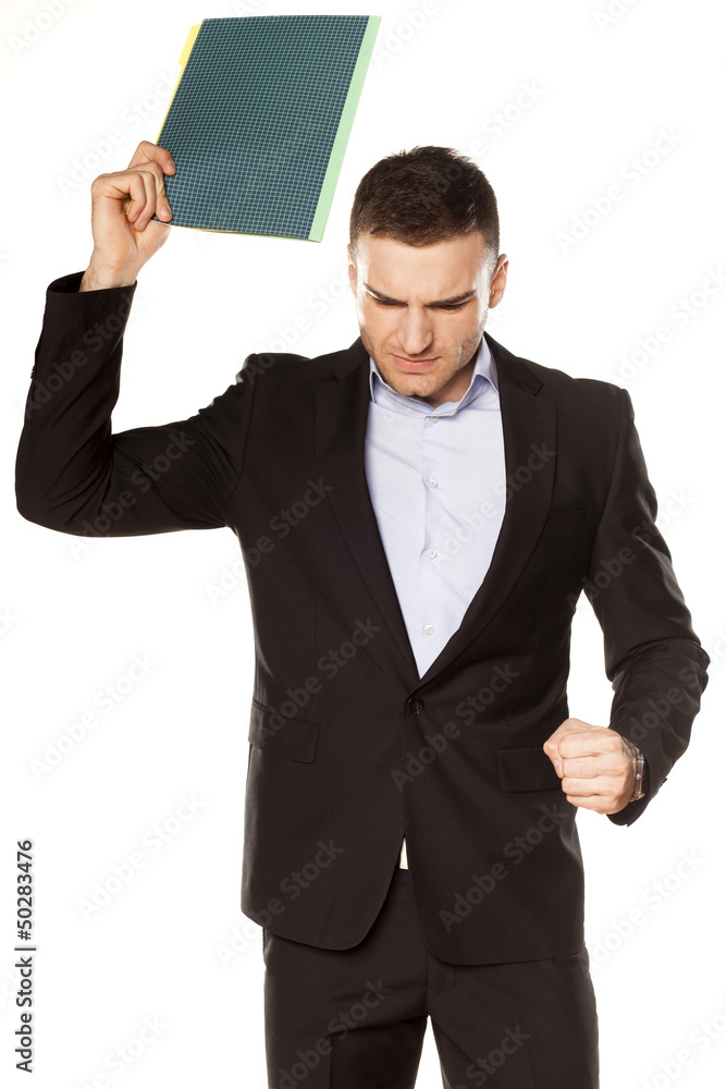 furious young businessman with folder in hand furious young businessman with folder in hand