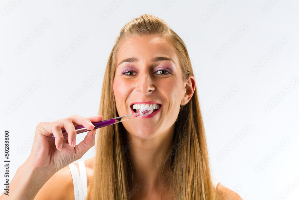 Woman brushing her teeth with toothbrush Woman brushing her teeth with toothbrush