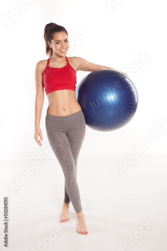 Happy shapely girl with a pilates ball