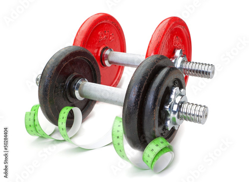 Two dumbbells for fitness and measuring meter. On a white backgr
