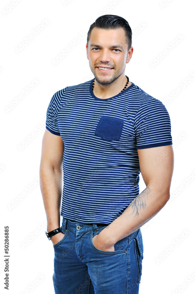 Fototapeta premium Handsome man casually posing with hands in a pockets