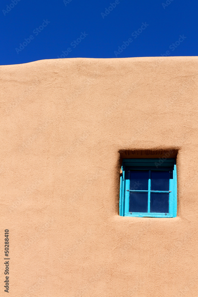 Obraz premium Blue window on adobe wall