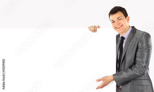 Happy smiling business man showing blank signboard