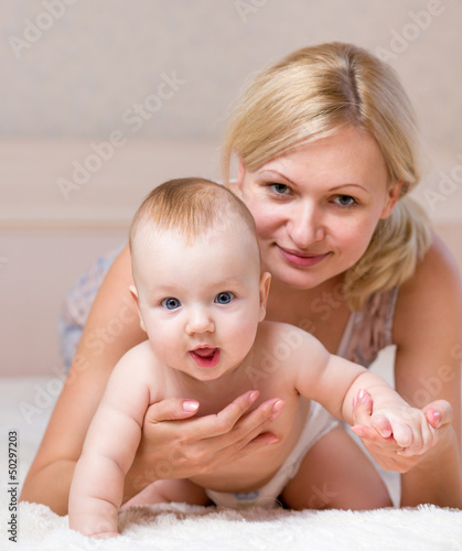 mother playing with baby bo...