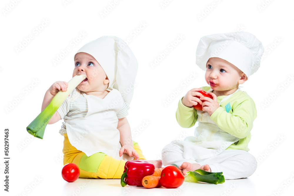babies boy and girl wearing a chef hat with healthy food vegeta babies boy and girl wearing a chef hat with healthy food vegeta