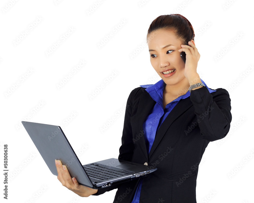 Isolated young business woman on a cell phne with laptop compute Isolated young business woman on a cell phne with laptop compute