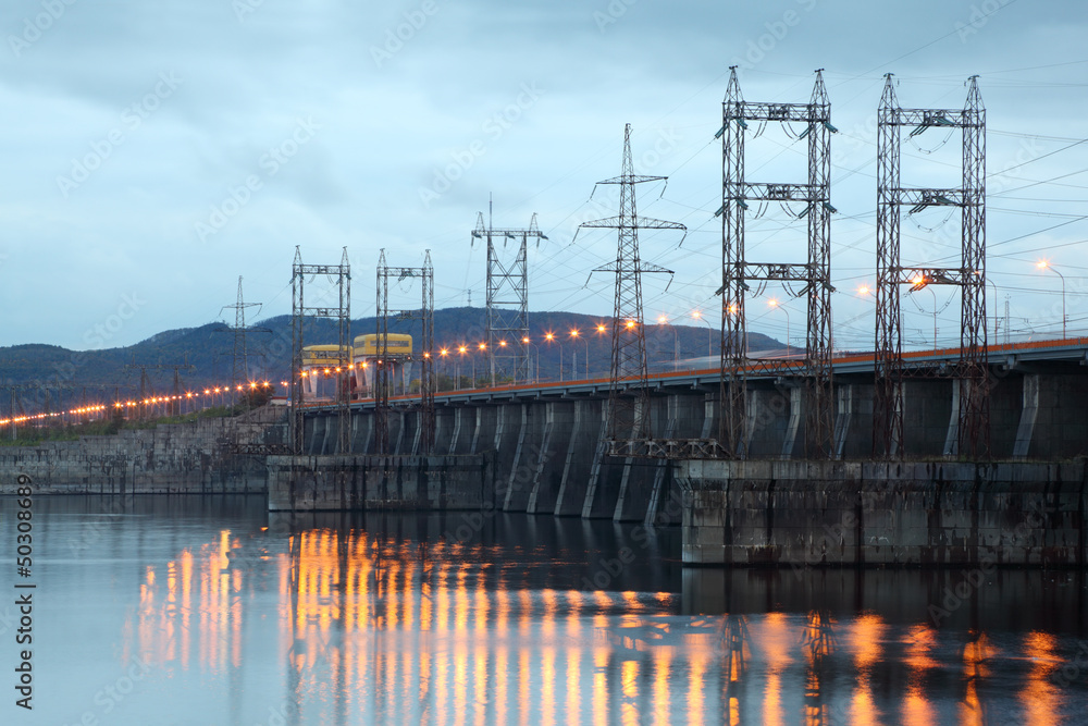 Hydroelectric power station on river at evening