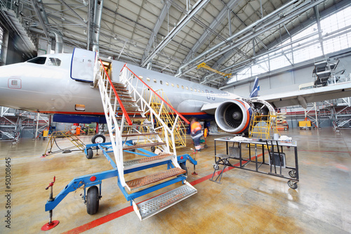 Repairing plane in hangar