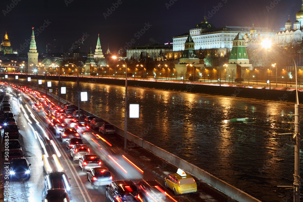 Moscow Kremlin, Moskva River and cars on road. Night cityscape.