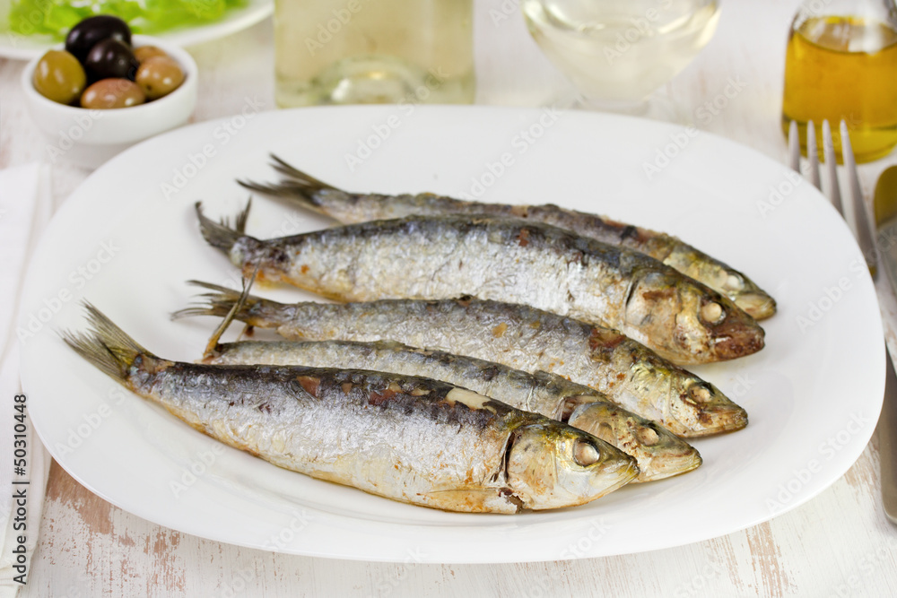 fried sardines on the white plate fried sardines on the white plate