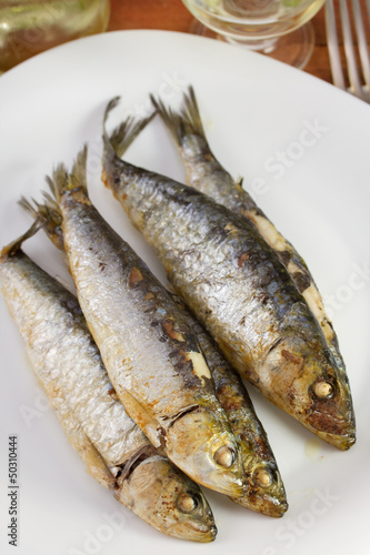 fried sardines on the white plate