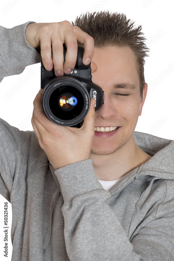 Junger Fotograf fotografiert mit Kamera in der Hand Junger Fotograf fotografiert mit Kamera in der Hand