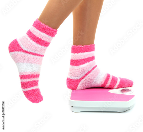 Feet on scales isolated on white