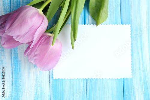 Fototapeta Naklejka Na Ścianę i Meble -  Beautiful bouquet of purple tulips and blank card