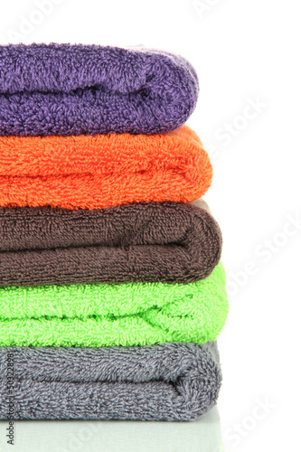 Pile of colorful towels, isolated on white