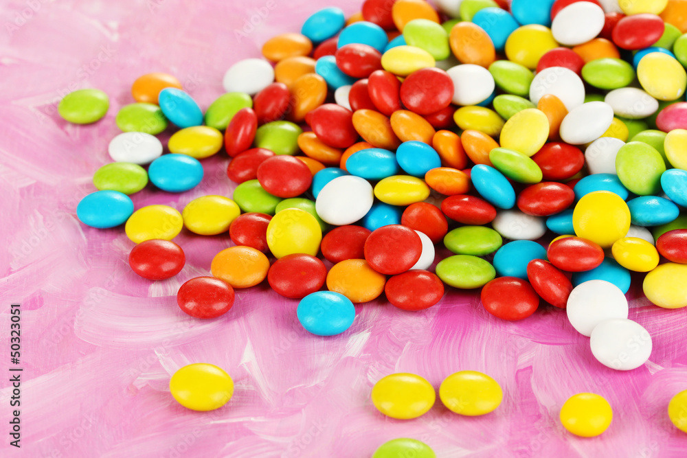 Colorful candies on pink background Colorful candies on pink background