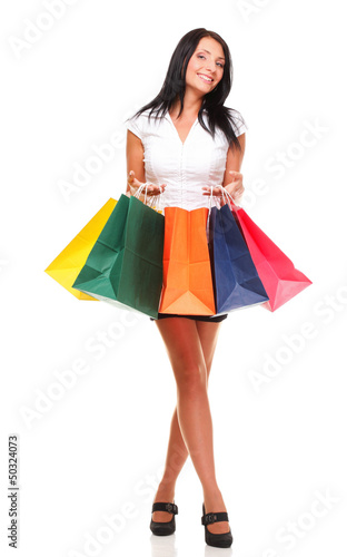 Portrait of young woman carrying shopping bags against white bac