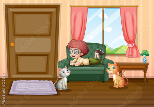 A young boy and his cats inside the house