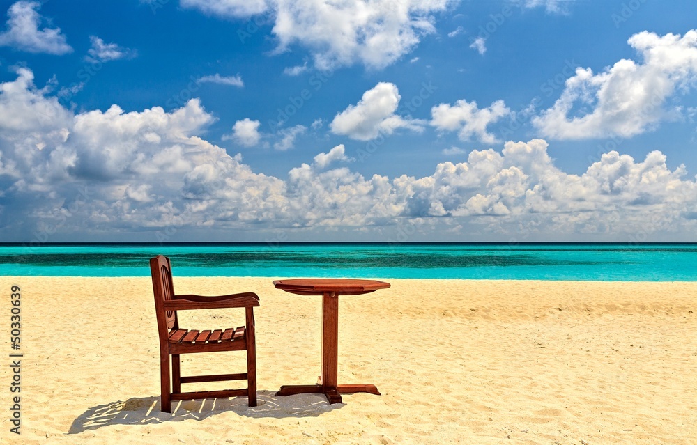 Chairs and table are on the beach Chairs and table are on the beach