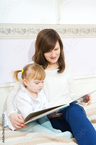 Mother and child reading book
