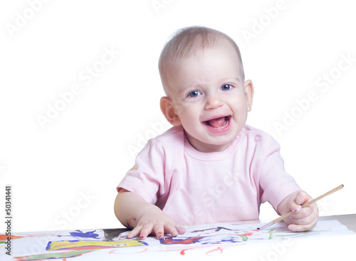 Cute baby girl draws paints