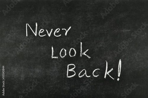 words "Never Look Back" on blackboard